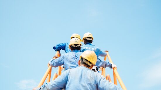 workers in a Singaporean shipyard disembark a gas vessel during a planned fire drill.